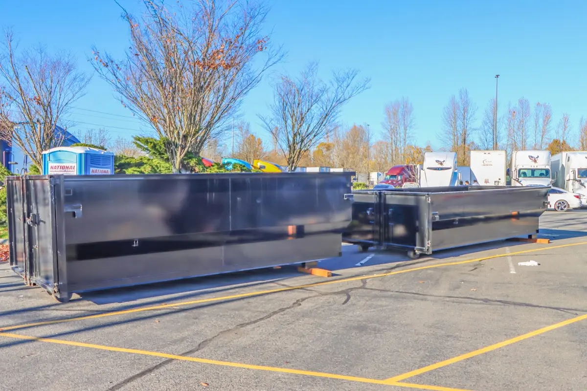 Professional dumpster rental service with roll-off container on residential driveway in Haslet